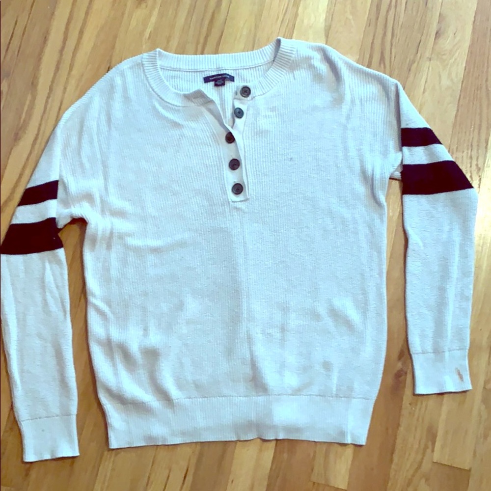 Cream sweater with black strips on the sleeves